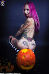 Halloween teen Brandy sitting on big pumpkin
